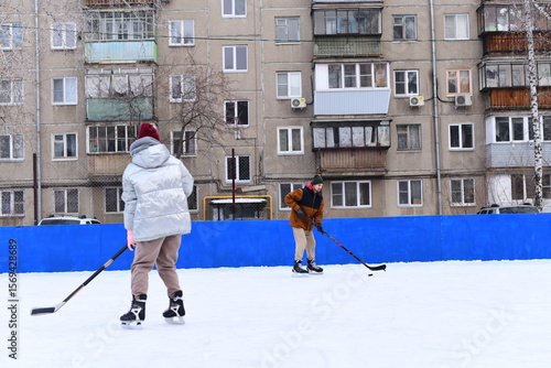 Photography People skate and play ice hockey in the yard