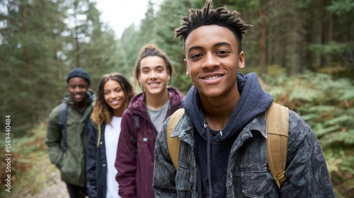 Group of diverse young adults hiking in forest.