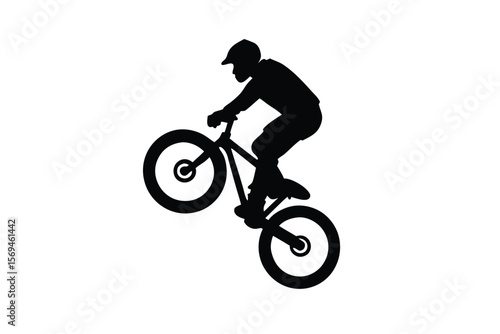Silhouette of a Biker Performing a Wheelie on a Mountain Bike