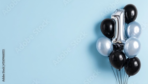 photo of number one balloon bouquet on light blue background with black and silver balloons for a first birthday party decoration. web banner wit wit wit wit wit wit