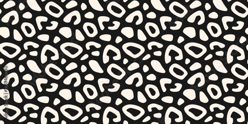 Stylish leopard print. Vector seamless pattern with spots, organic shapes. Cut-out style animal skin texture, jaguar, cheetah, leo fur. Abstract black and white background. Repeated all-over design