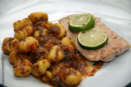 salmon with gnocchi, basil-tomato pesto and tomato and mozzarell
