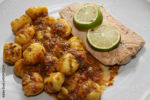 salmon with gnocchi, basil-tomato pesto and tomato and mozzarell