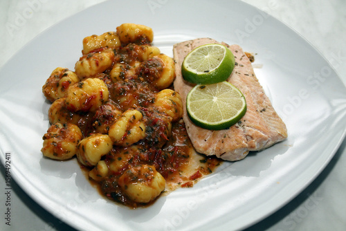 salmon with gnocchi, basil-tomato pesto and tomato and mozzarell