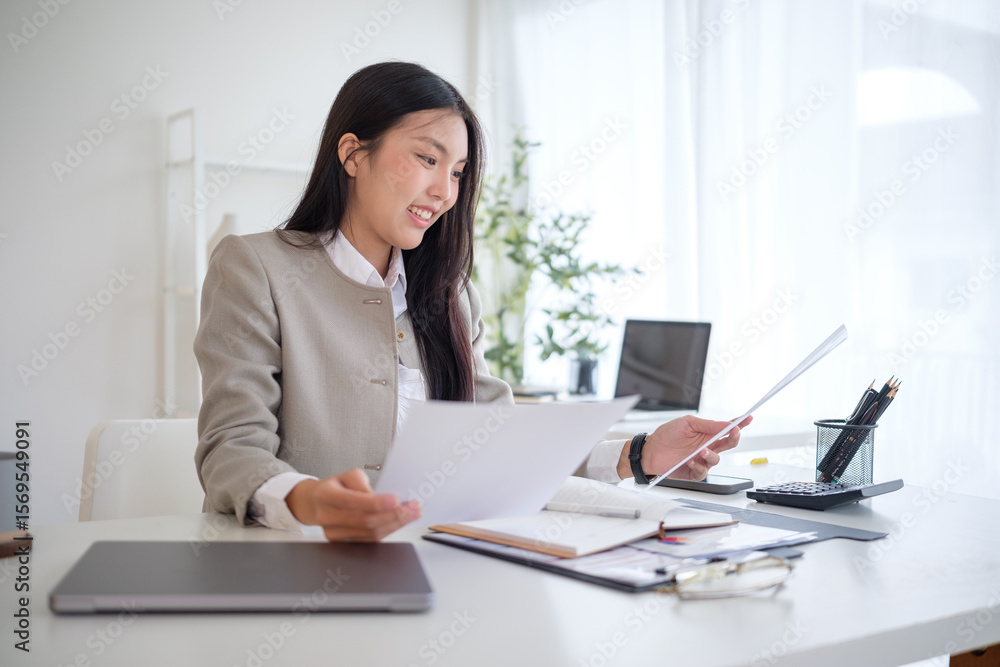 Smiling businessman holding paperwork and checking details for a business project. Smiling businessman holding paperwork and checking details for a business project.
