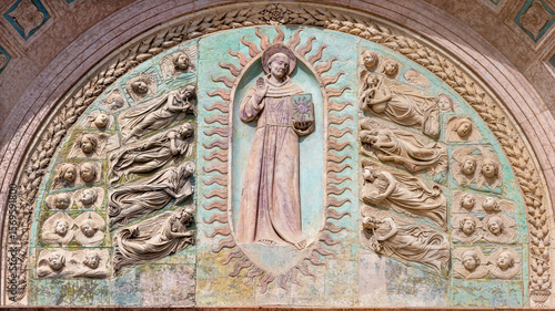 Perugia - The relief of St. Bernardine of Siena on the facade of church Oratorio dei Santi Andrea e Bernardino by Agostino di Duccio (1418 – 1481).