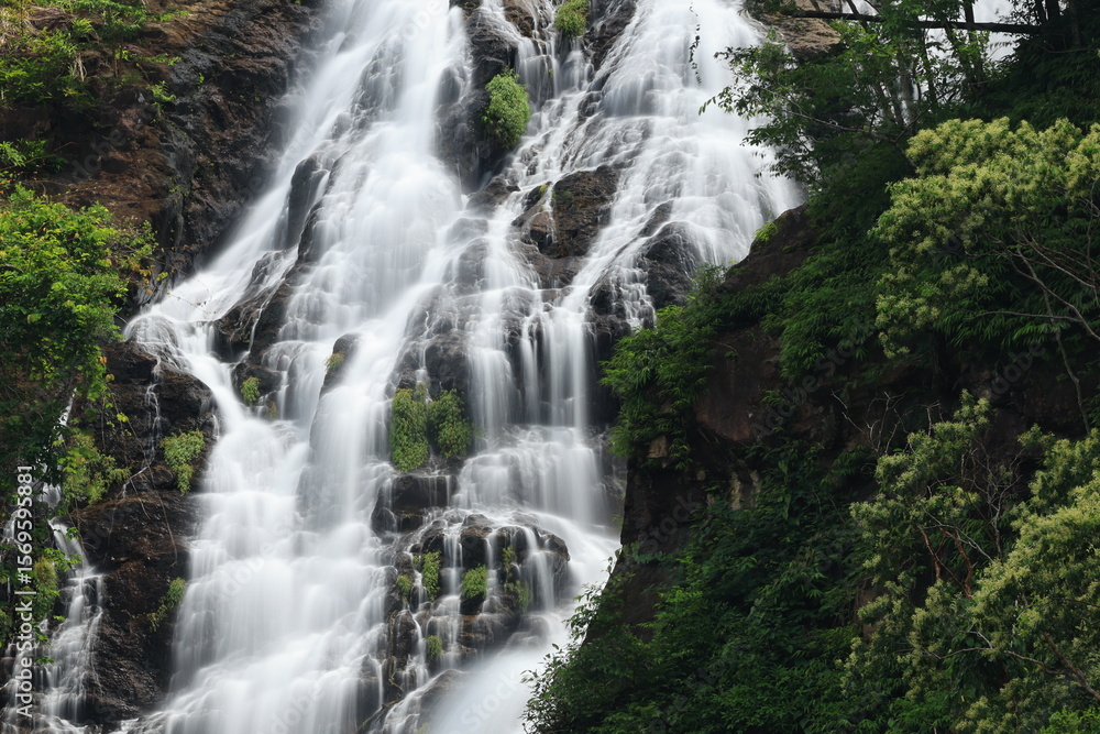 Fototapeta premium Namtok Sarika is the most famous waterfall in Nakhon Nayok , The nine-tiered waterfall cascading down the cliff to a forested hillside has a large natural pool on each level . THAILAND 