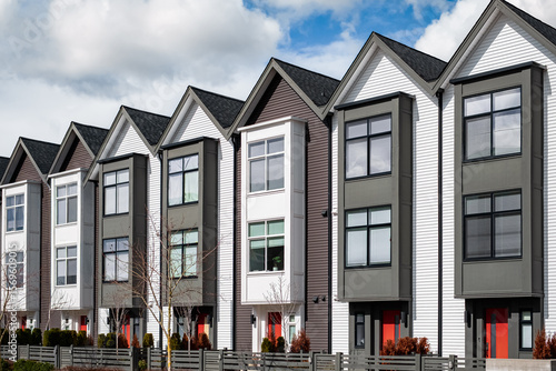 Real Estate Exterior Front townhomes. Facade of a row of modern urban townhouses