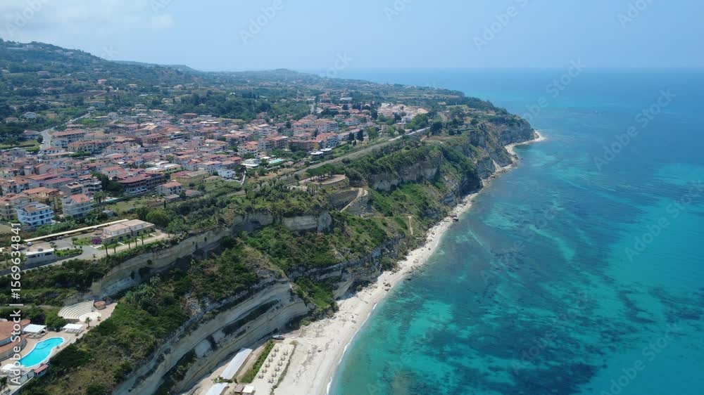Italian Cliffside Village Above Turquoise Sea – Aerial Panorama from Calabria Italian Cliffside Village Above Turquoise Sea – Aerial Panorama from Calabria