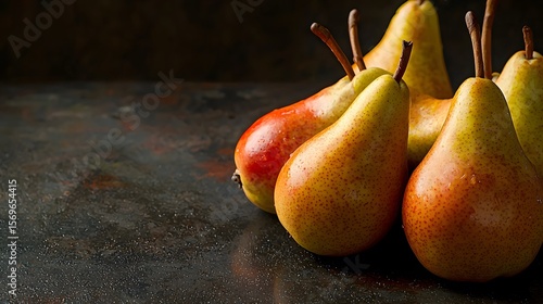 A cluster of ripe, juicy pears sits on a dark rustic surface providing ample copy space for text ideal for culinary websites blogs or food packaging designs showcasing the