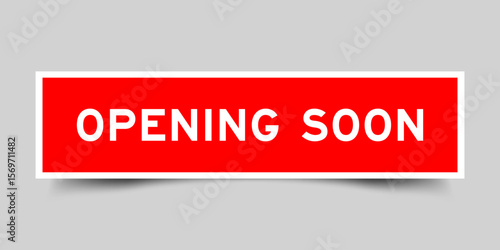 Red color square shape sticker label with word opening soon on gray background