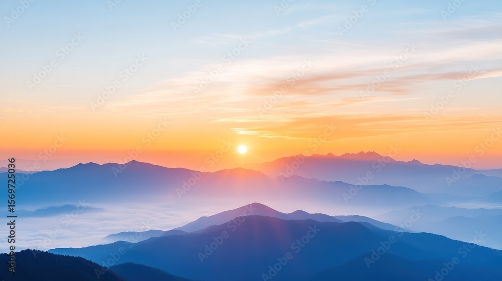 Fototapeta premium A stunning sunrise illuminating mountain peaks with gentle clouds, creating a serene and breathtaking natural view.