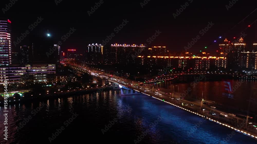 Night view showcasing the illuminated Hunt Bridge and bustling cityscape along the river Night view showcasing the illuminated Hunt Bridge and bustling cityscape along the river