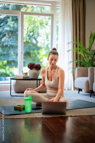 Wallpaper Mural Smiling woman relaxing after online training at home Torontodigital.ca