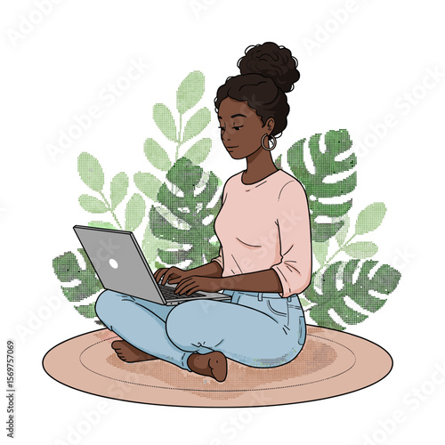 Young black woman working on laptop while sitting on a mat indoors  