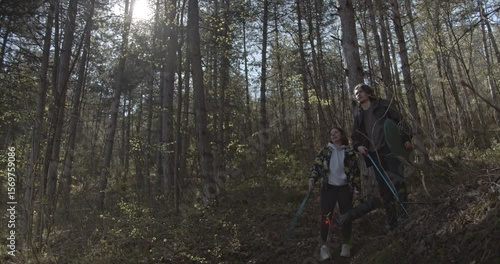 Wallpaper Mural Young couple enjoy their hike through a lush forest, pointing and laughing as they explore nature's beauty together. Torontodigital.ca