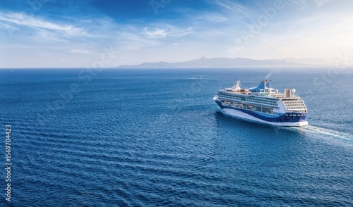 Fototapeta Naklejka Na Ścianę i Meble -  Panoramic aerial rear view of a cruise ship sailing over blue ocean with copy space as a banner for cruise travel