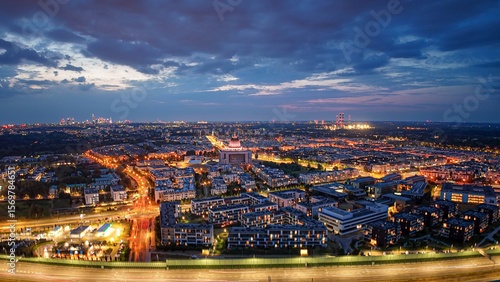 Wide, aerial, night panorama of illuminated Vilanów district in Warsaw