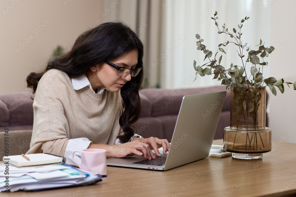 Beautiful woman in shirt using laptop while working at home Beautiful woman in shirt using laptop while working at home