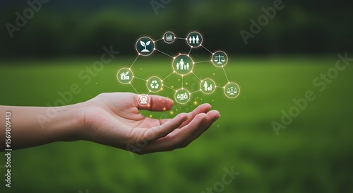 Human hand holding a network of icons representing sustainability and society