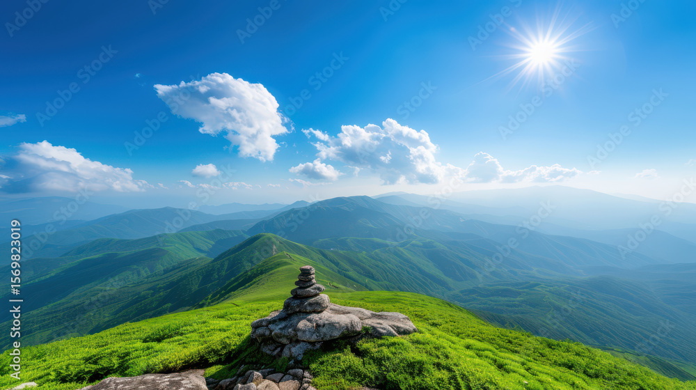 Fototapeta premium A mountain top with a small stone on it and a clear blue sky