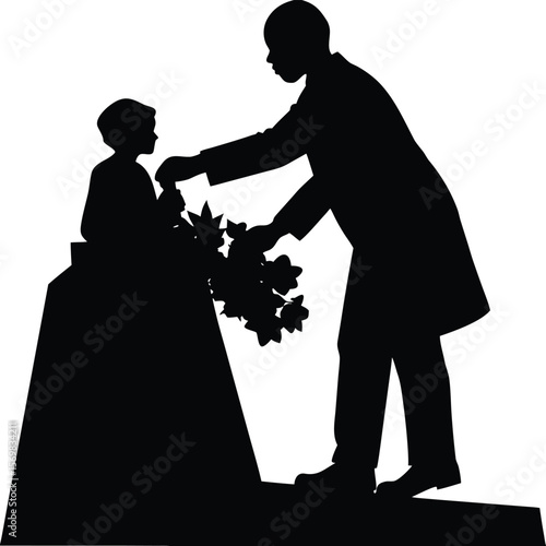 Silhouette of a Man Placing Flowers on a Statue in Solemn Remembrance Displaying Affection and Respect