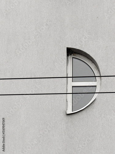 Monochrome urban geometry: tram wires through a small window