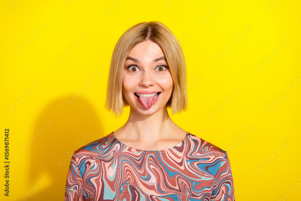 Playful young woman making a funny face in a vibrant background wearing a trendy printed top showcasing her lively style Playful young woman making a funny face in a vibrant background wearing a trendy printed top showcasing her lively style
