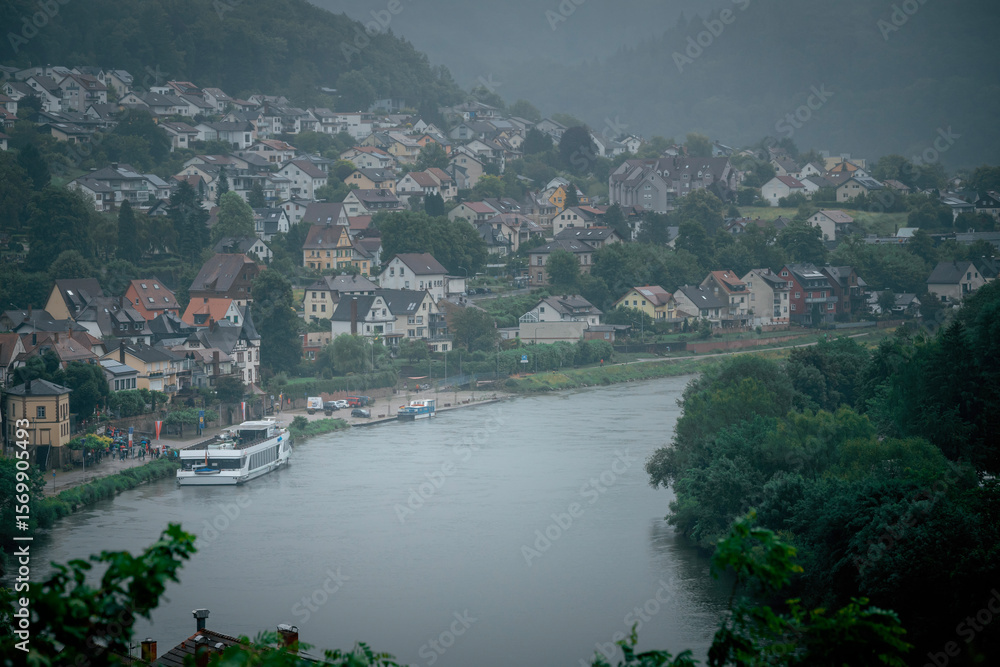 Fototapeta premium Dramatic Clouds Over the Neckar River in Neckarsteinach, Germany