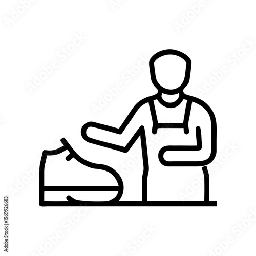 Man repairing shoe while standing at workbench in workshop  