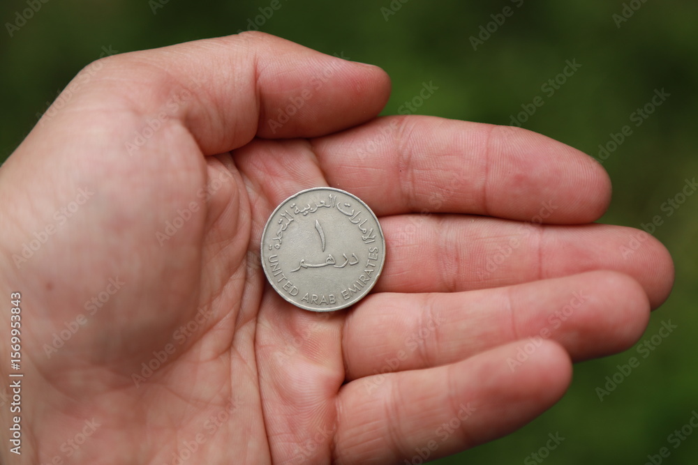 Fototapeta premium Coin one dirham of United Arab Emirates in hand