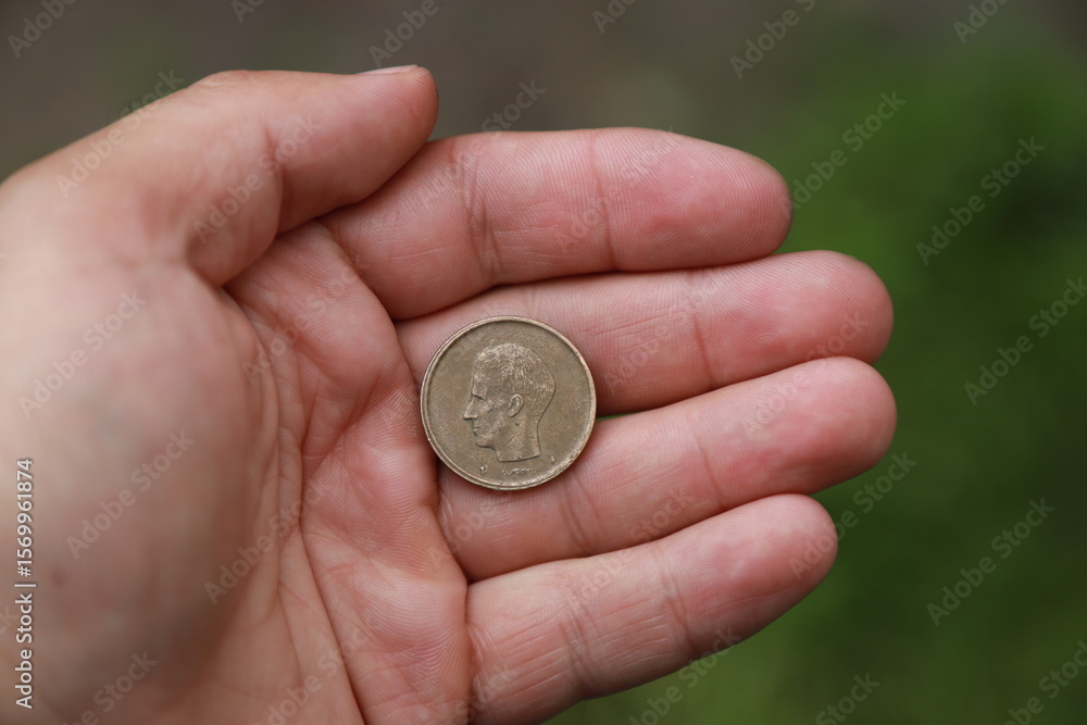 Belgian change coin in hand Belgian change coin in hand