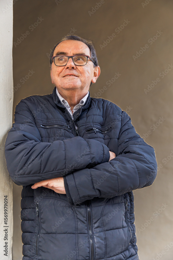 Fototapeta premium Elderly caucasian male in black jacket looking thoughtful outdoors