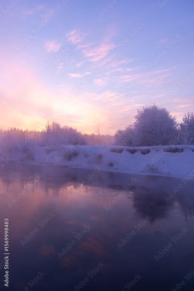 Fototapeta premium Dawn on a frosty morning on the river in winter