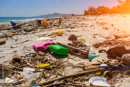Fototapeta Naklejka Na Ścianę i Meble -  Public city beach shows significant pollution ecological disaster plastic containers, household waste, bottles, debris scattered along shoreline. Efforts to clean up area critical ecosystem storm