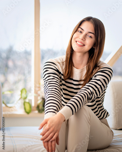 Brunette haired woman sitting in living room and cheerful smiling Free Download Brunette haired woman sitting in living room and cheerful smiling - GFXLoad