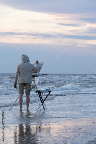 A painter painting the waves on a windy day