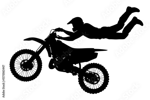 Silhouette of a motocross rider performing a stunt