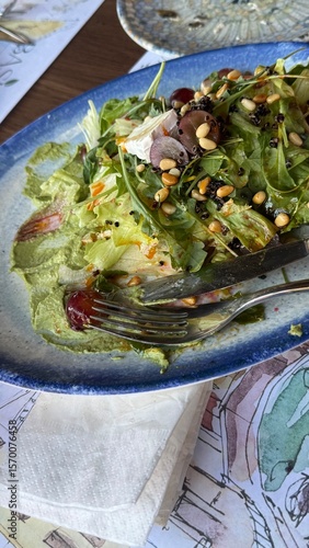 salad with pine nuts in a plate on a table in an Italian restaurant