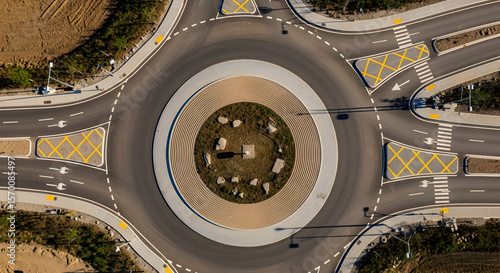 Aerial View Of Modern Road Roundabout With Pedestrian Crossings In Cityscape
