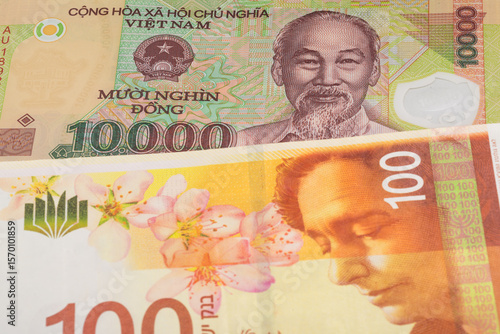 Wallpaper Mural 10000 Vietnamese dong and 100 Israeli shekel banknotes. International trade concept Torontodigital.ca