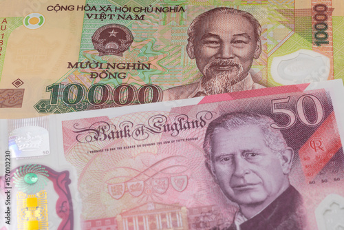 Wallpaper Mural 10000 Vietnamese dong and 50 British pound banknotes. International trade concept Torontodigital.ca