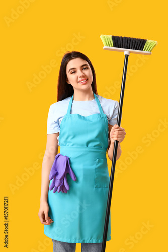 Female janitor with broom o...