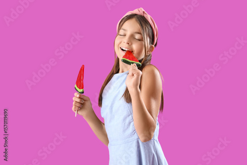 Happy little girl eating lo...