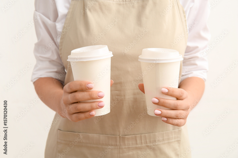 Woman with takeaway cups of hot coffee on white background Woman with takeaway cups of hot coffee on white background