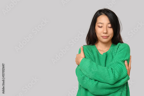 Young Asian woman hugging h...