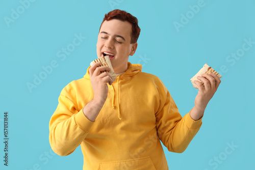 Young man eating tasty done...