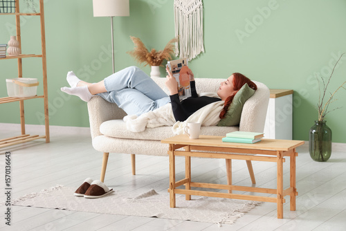Young woman reading magazin...