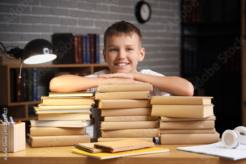 Teenage boy with stacks of ...