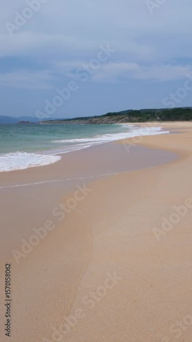 Wallpaper Mural Tranquil turquoise waves washing onto the golden sands of playa queiruga, galicia, spain, creating a serene coastal paradise Torontodigital.ca